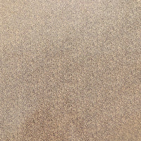 A close-up texture of a dense, pebbled leather or faux-leather material in a mix of beige, tan, and brown tones.