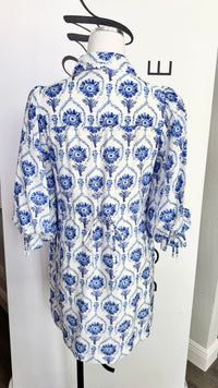 Blue and white patterned dress on a mannequin against a white background