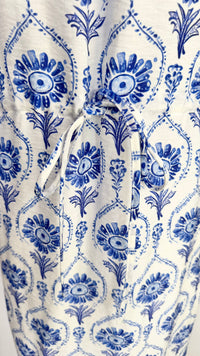 White dress with blue floral pattern on a white background