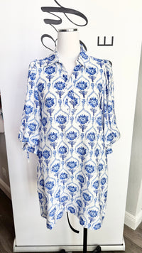 Blue and white floral patterned dress on a mannequin against a white background
