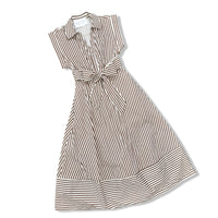 A sleeveless collared dress with vertical brown and white stripes, featuring a tie waist and a flared skirt, shown on a plain white background.