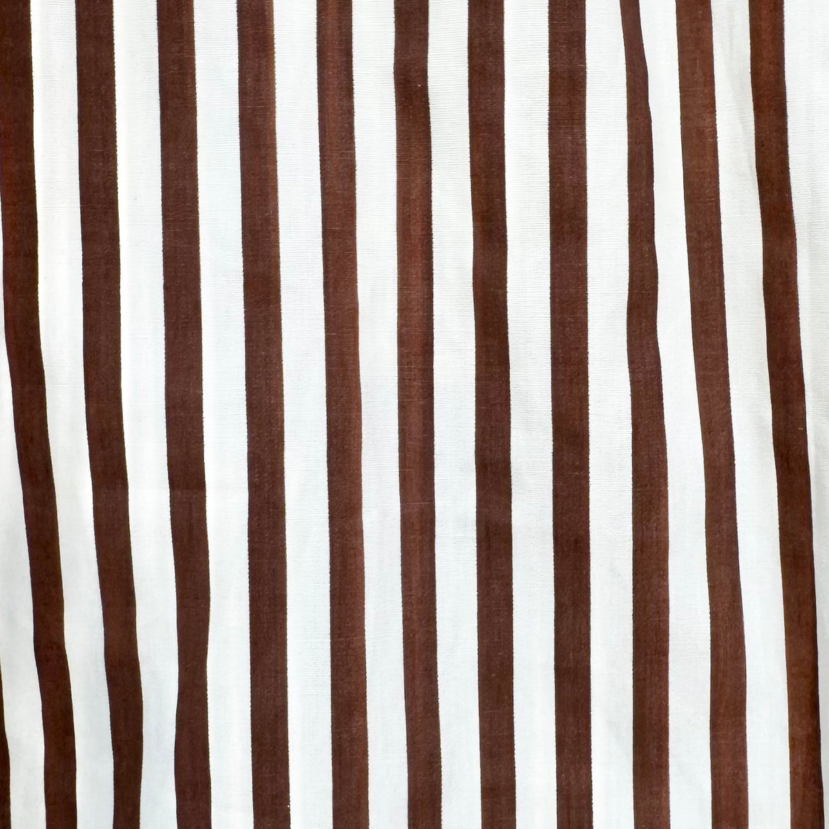 A close-up of a striped fabric pattern featuring alternating vertical stripes of dark brown and white.