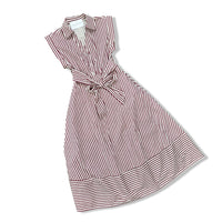 A sleeveless collared dress with vertical red and white stripes, featuring a tie waist belt and a wide striped hem, shown on a plain white background.