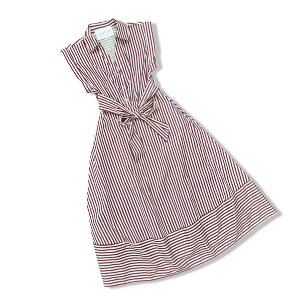 A sleeveless collared dress with vertical red and white stripes, featuring a tie waist belt and a wide striped hem, shown on a plain white background.