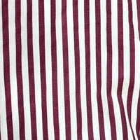 A close-up of a striped fabric with alternating vertical stripes of deep burgundy and white.