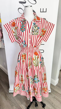 Red and white striped dress with floral patterns on a mannequin against a white background.