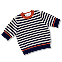 A knit sweater with horizontal navy blue and off-white stripes, featuring a contrasting orange crew neck, hem, and sleeve trim, shown on a white background.