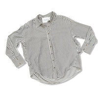 A long-sleeve button-up shirt with vertical dark blue and cream stripes, laid flat on a white background.