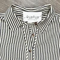 A close-up of a dark blue and cream vertically striped button-down shirt with a pointed collar and a visible neck label reading 'bizzy lizzy BOUTIQUE'.
