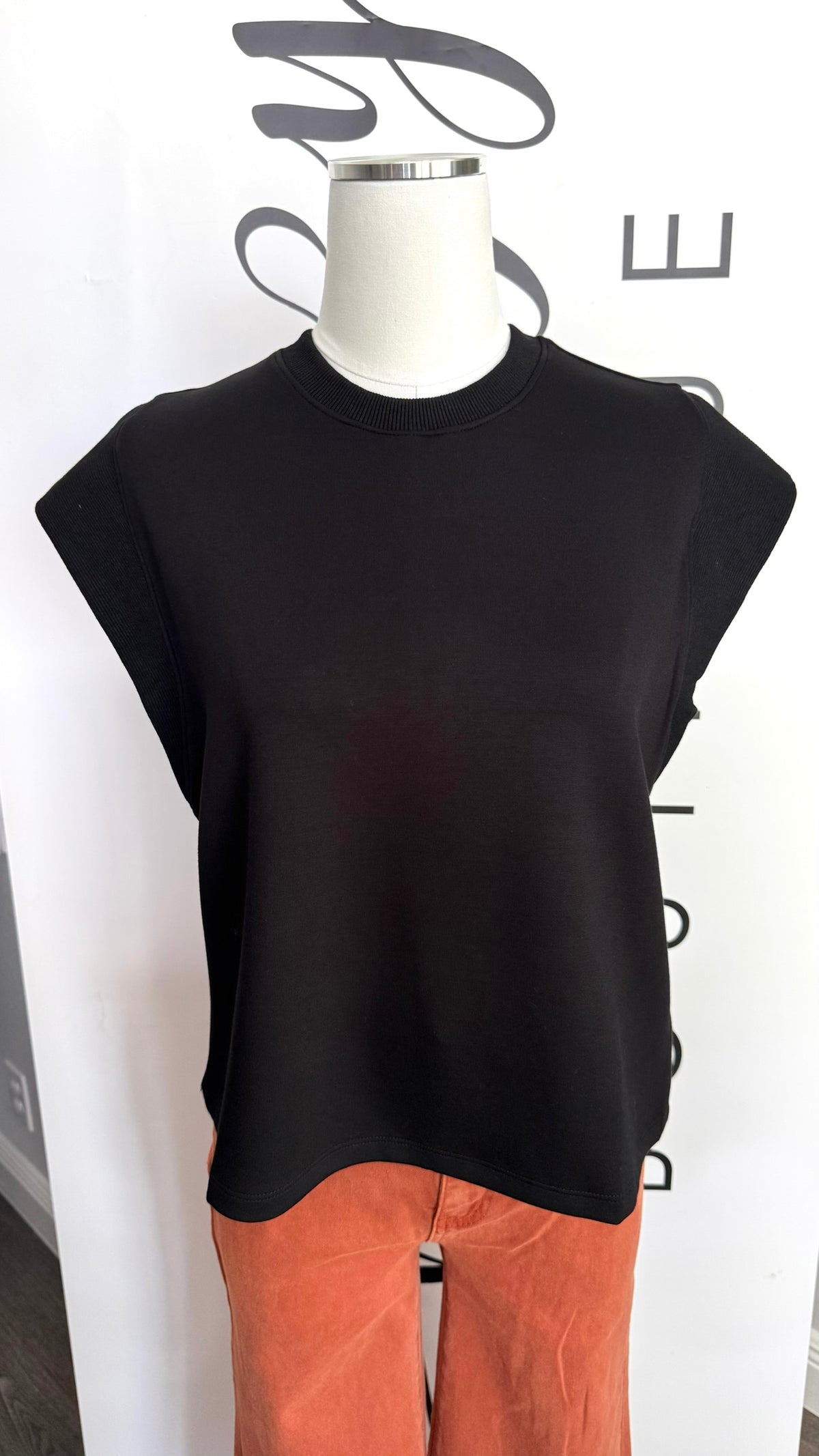 Entro Cap Sleeve Black Top Blanco Top on Mannequin Close Up in Game Day Orange Pants
