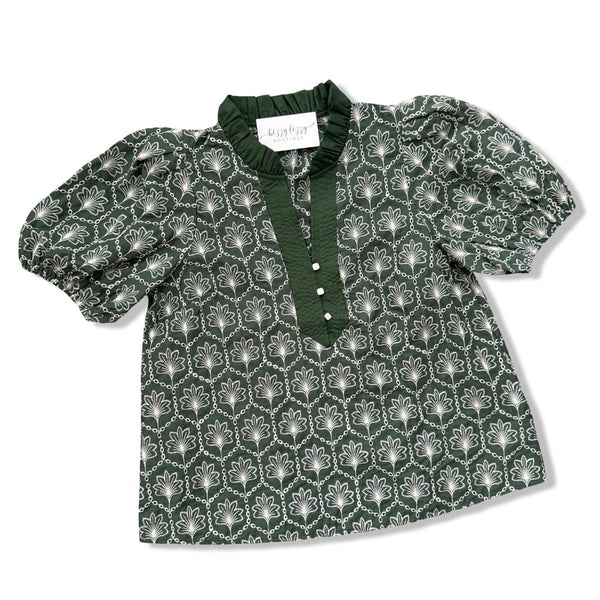 A dark green short-sleeve blouse with a white geometric pattern, featuring a ruffled collar, buttoned placket, and puffed sleeves, laid flat on a white background.