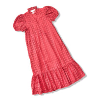 A rust orange eyelet dress with puff sleeves, a high collar, and a ruffled hem, shown on a plain white background.