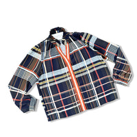 A long-sleeve plaid shirt with a navy blue base and intersecting stripes of white, red, orange, and light blue, featuring a split collar and button closure.