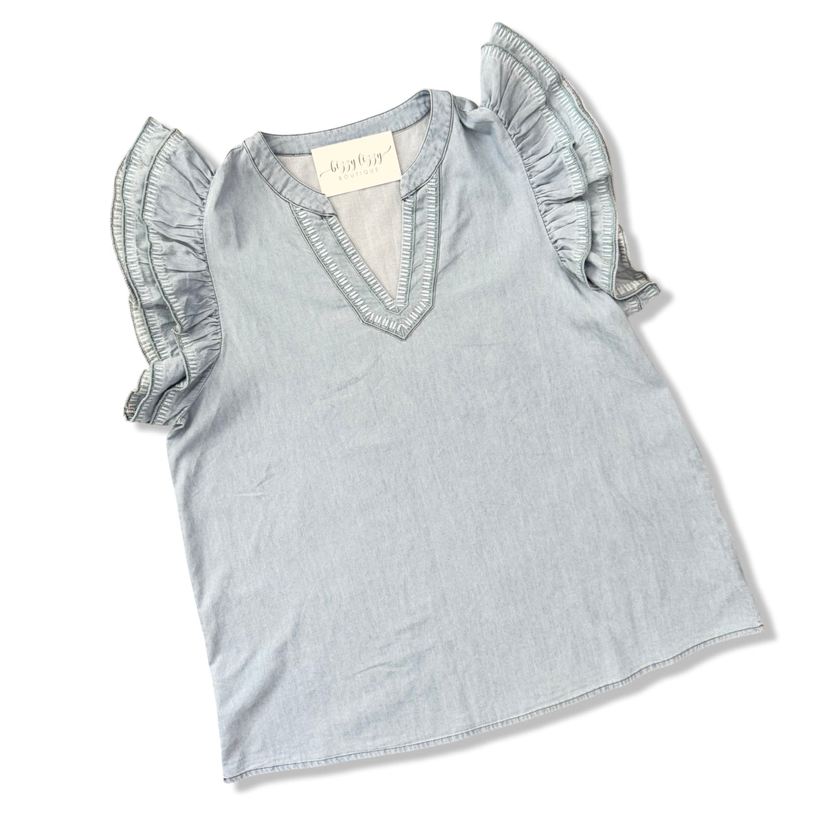 Light blue top with ruffled sleeves on a white background