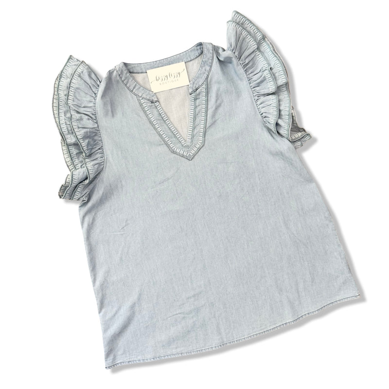 Light blue top with ruffled sleeves on a white background