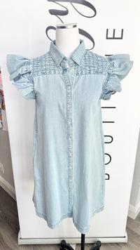 Light blue denim dress on a mannequin with a blurred background