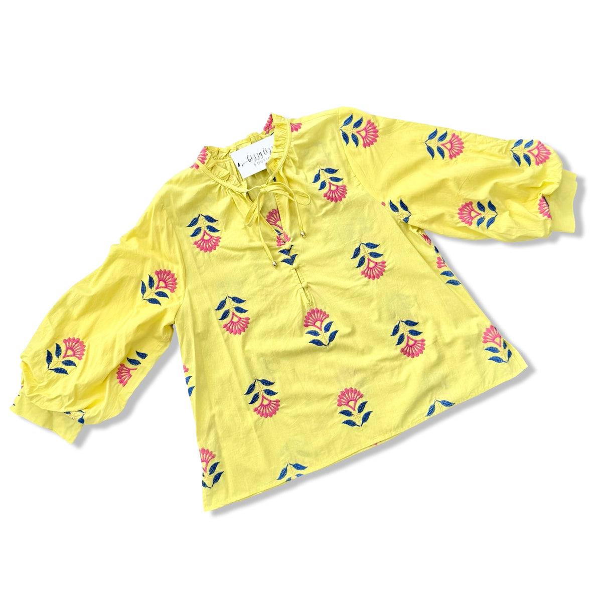 Yellow blouse with floral patterns on a white background