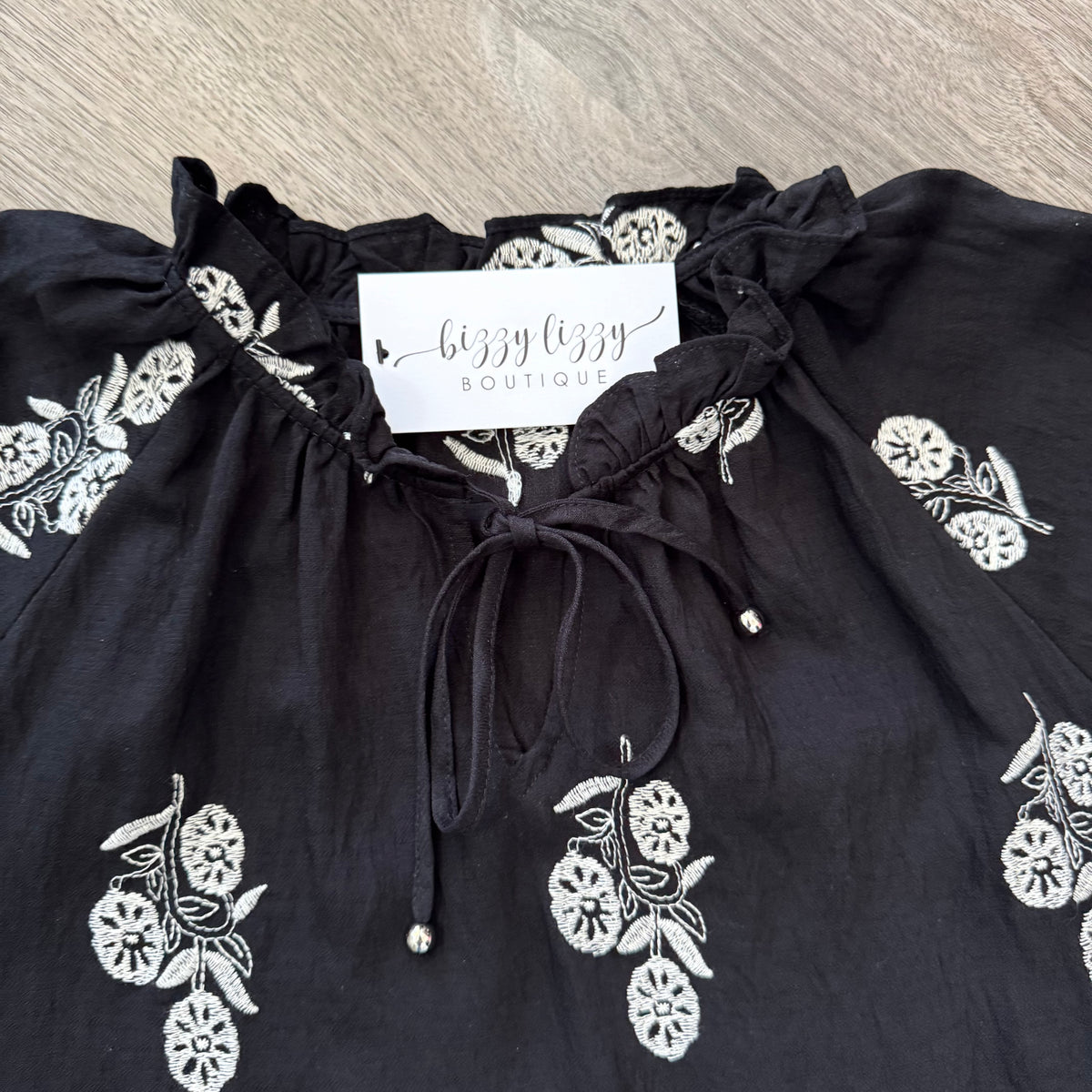 Natalie Entro Embroidered Top Black Collar Close Up with tie at neck