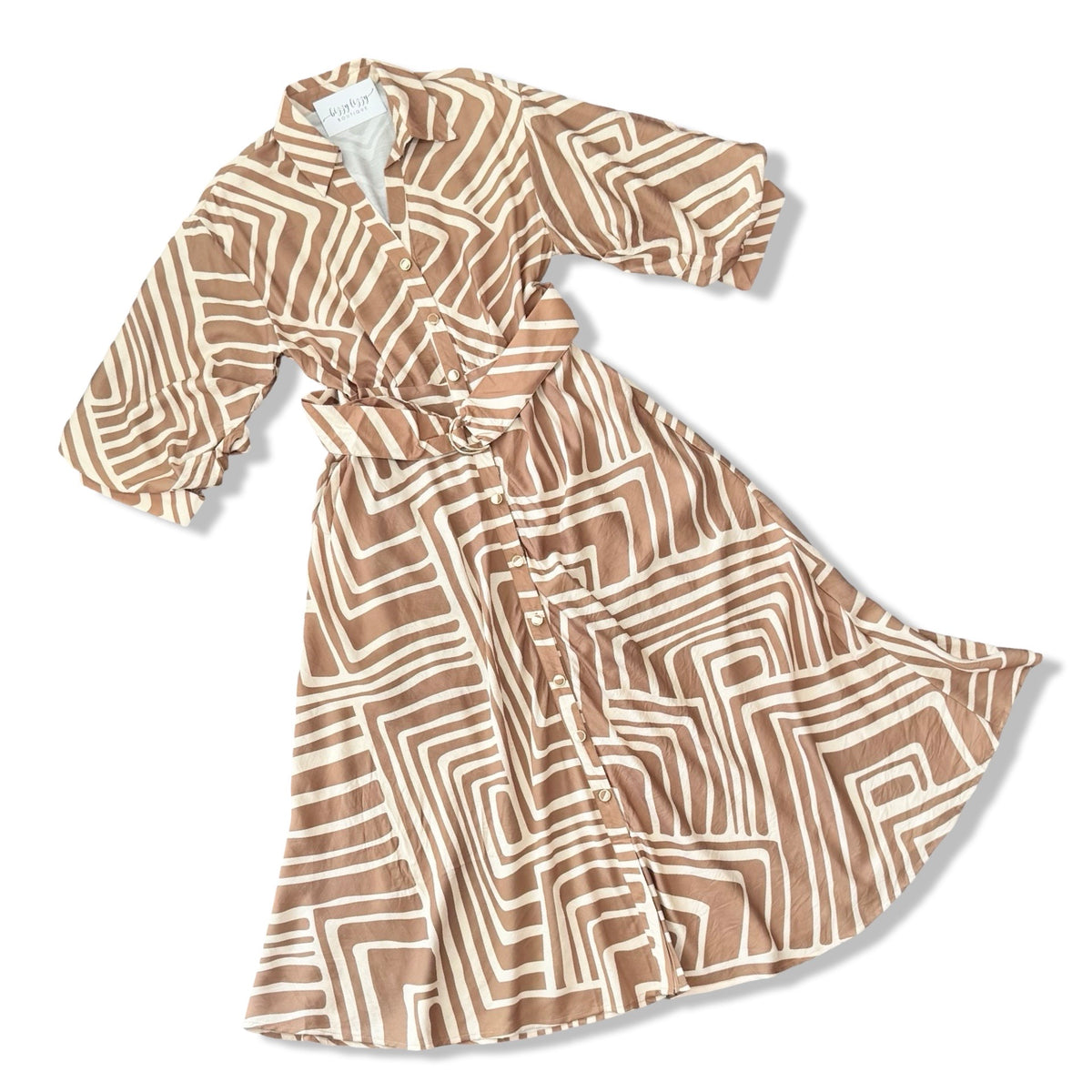 A women's long-sleeve wrap dress with a geometric maze-like pattern in tan and cream, shown on a white background.